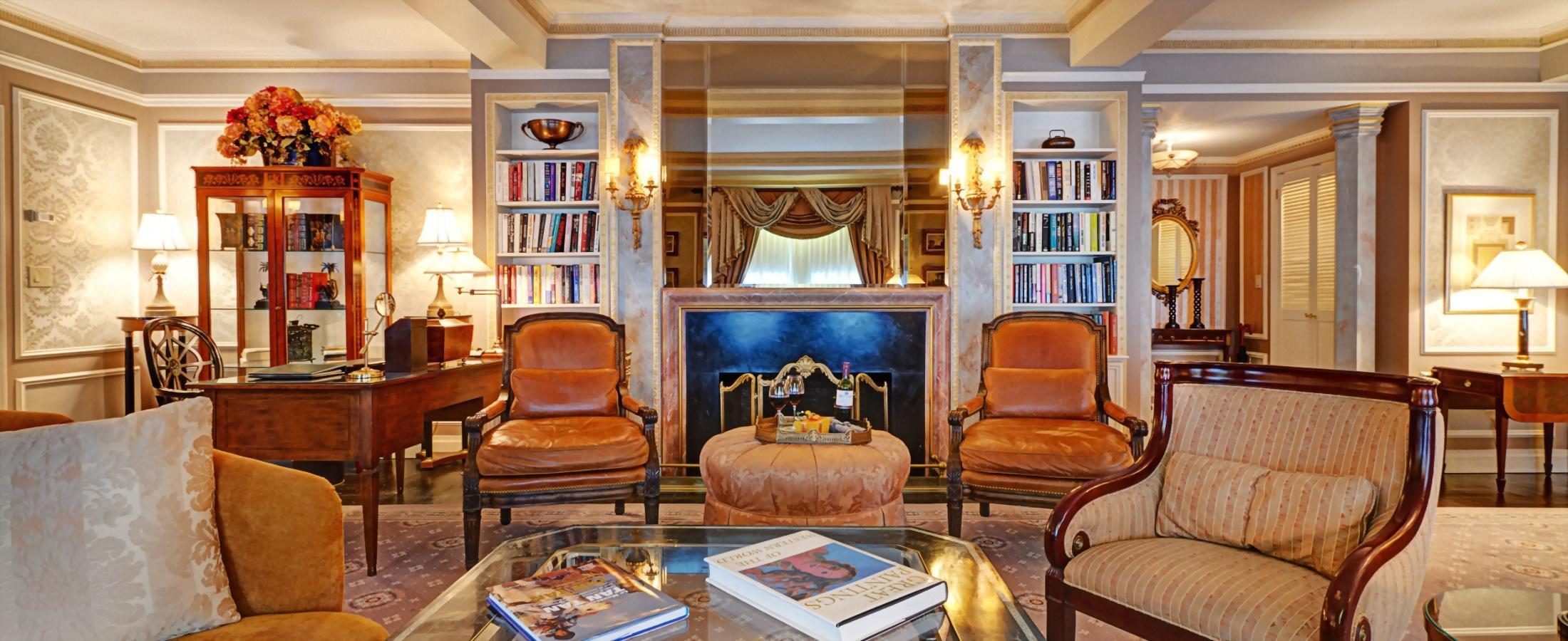 The living room of the Presidential Suite honoring Vaclav Havel boasts a faux fireplace, a baby grand piano, and large dining table.