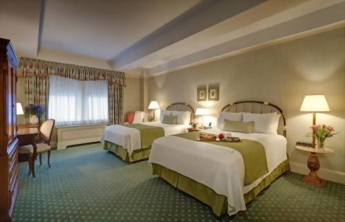 Deluxe room with 2 full sized beds at the Hotel Elysee New York by Library Hotel Collection.  Approximately 300 square feet and suitable for up to 2 adults.