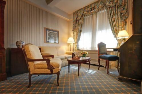 Most of the Deluxe Queen rooms at the Hotel Elysée have sitting areas with a couch, chair and a coffee table.
