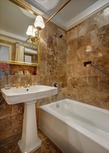 Beautiful marble bathrooms in the guest rooms at the Hotel Elysée feature pedestal sinks and most have bathtubs.