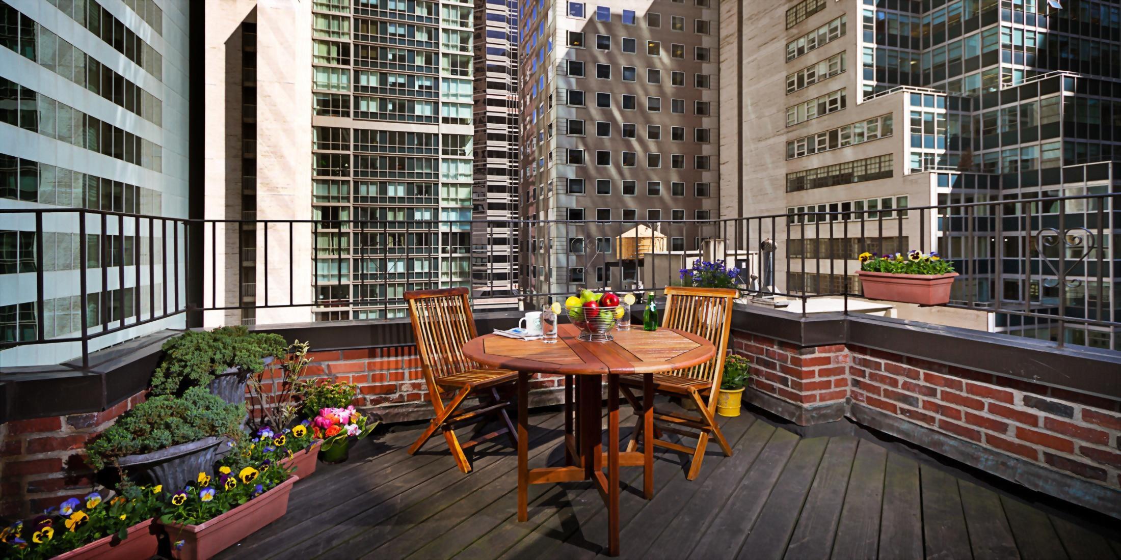 outdoor terrace with table overlooking streets of midtown Manhattan