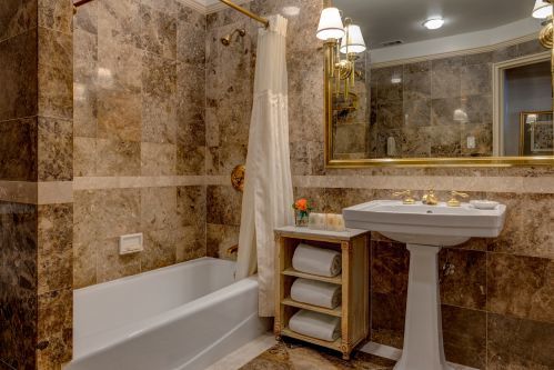 Each room at the Hotel Elysee is equipped with a classic marble bathroom.